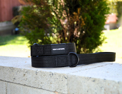 Black Tactical Lead on a concrete surface with a blurred outdoor background