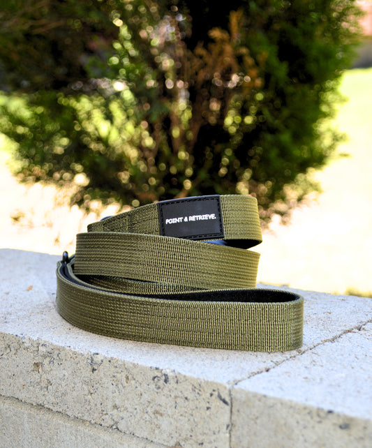 Green Lead a brand label on a stone surface with a blurred natural background