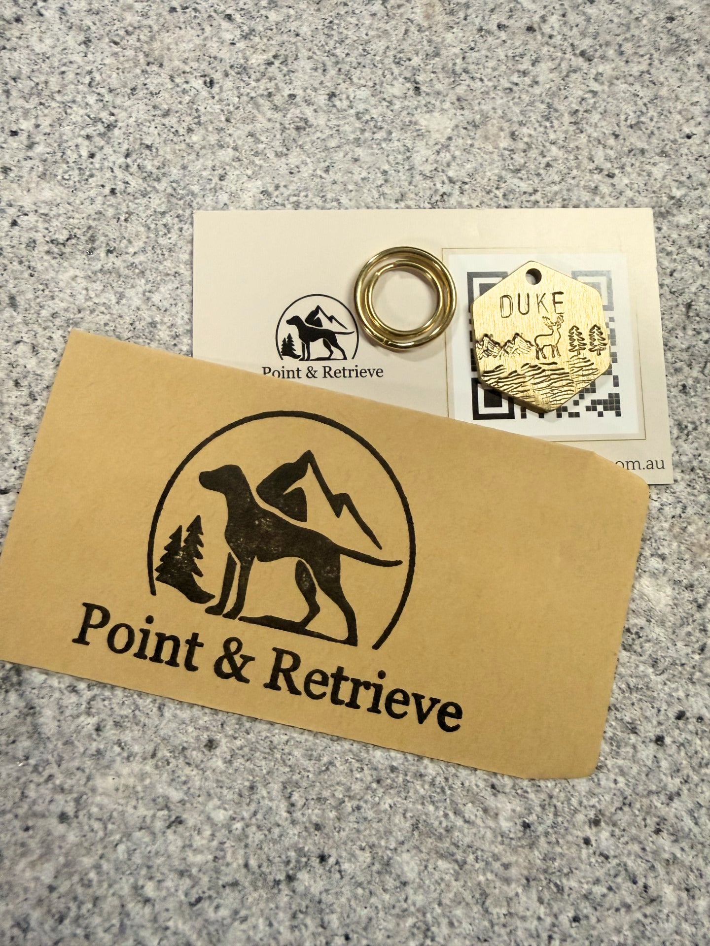 Point & Retrieve branded card with a dog silhouette logo on a textured surface