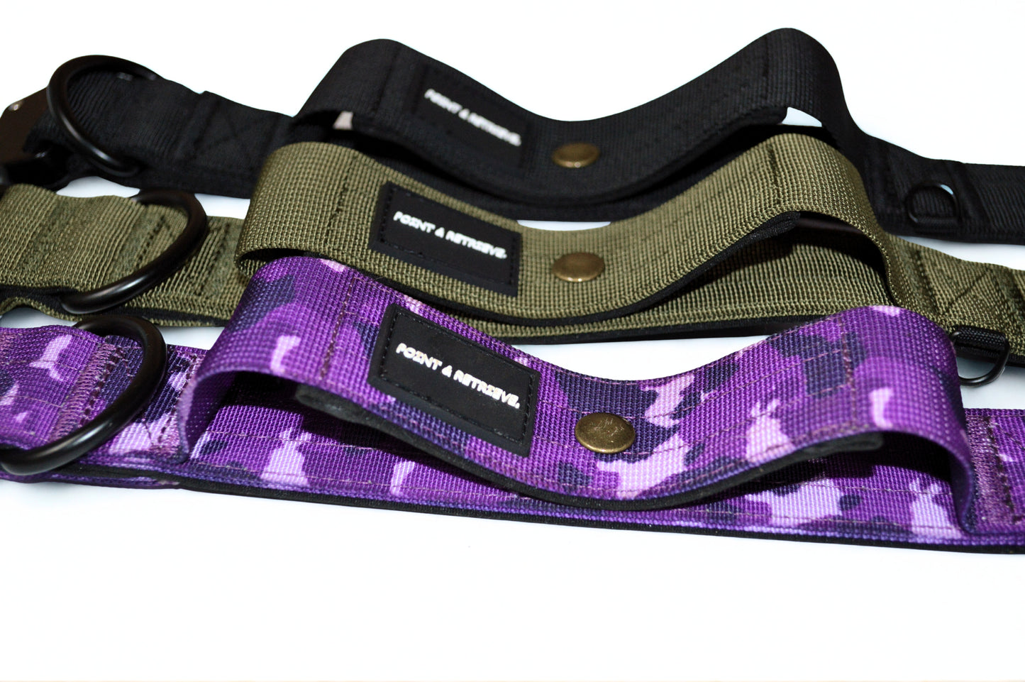 Three tactical collars in black, green, and purple camouflage pattern on a white background