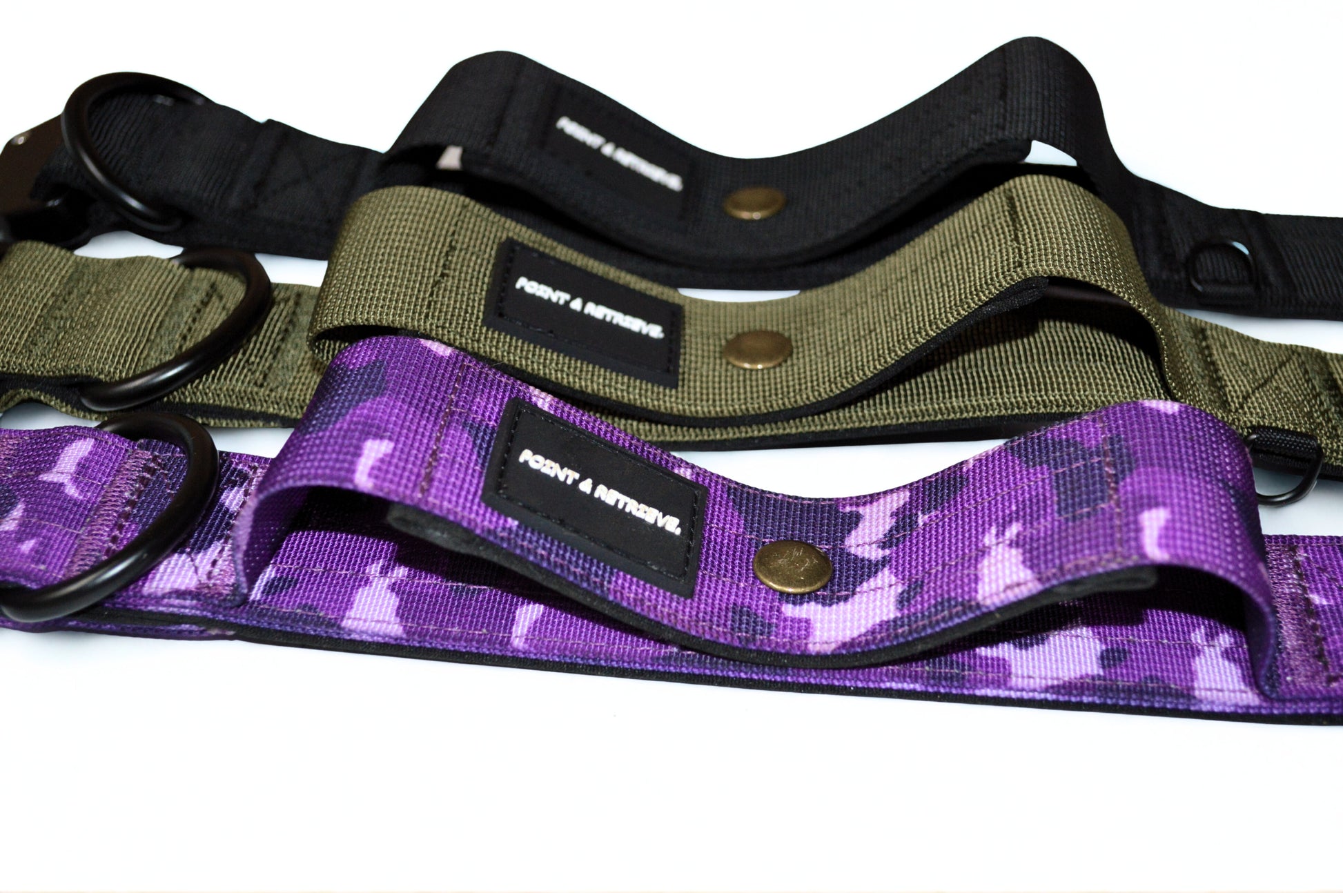 Three tactical collars in black, green, and purple camouflage pattern on a white background